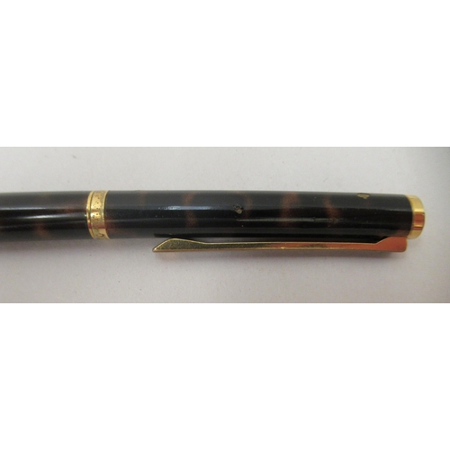 136 - A Dunhill ballpoint pen with a turning roller, gold plating and tortoiseshell effect ccasing  c... 