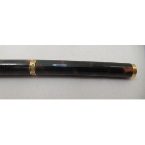 136 - A Dunhill ballpoint pen with a turning roller, gold plating and tortoiseshell effect ccasing  c... 