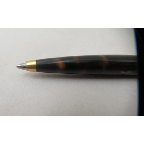 136 - A Dunhill ballpoint pen with a turning roller, gold plating and tortoiseshell effect ccasing  c... 