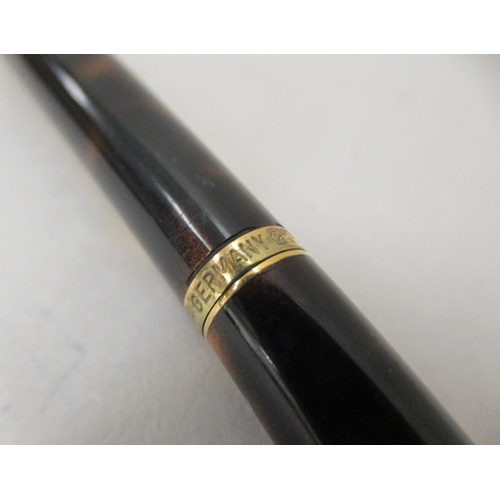 136 - A Dunhill ballpoint pen with a turning roller, gold plating and tortoiseshell effect ccasing  c... 