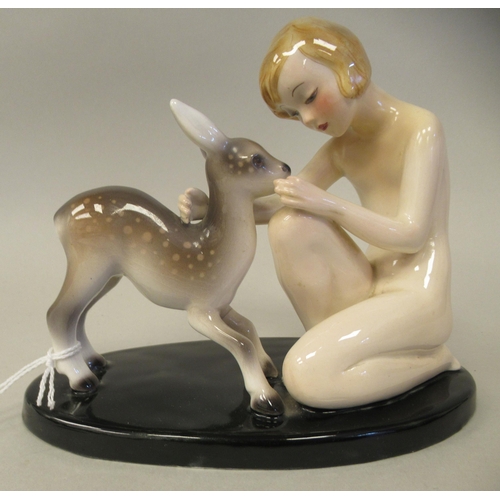 128 - An Art Deco Goldscheider, Claire Weiss porcelain group, a girl kneeling with a fawn, on an oval base... 