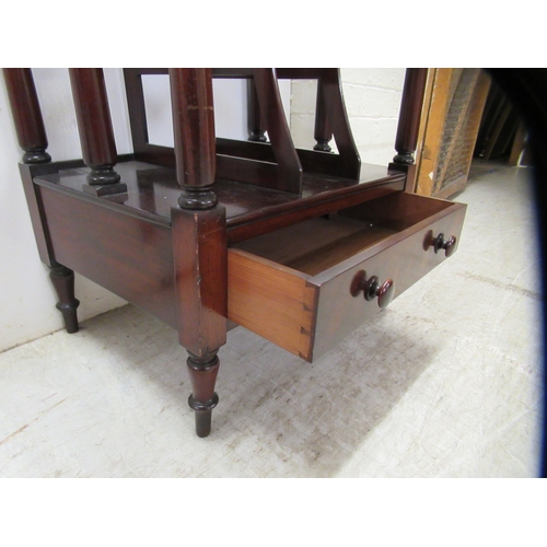 13 - A mid 19thC mahogany three tier Canterbury, comprising a galleried shelf top, the two lower levels f... 