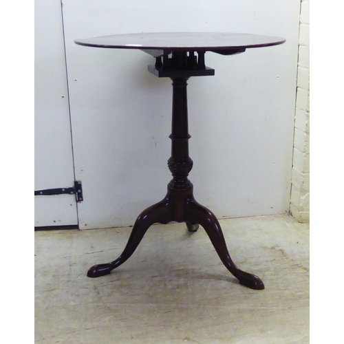 15 - An early 19thC style mahogany pedestal table, the tip-top on a birdcage and a wrythen carved and tur... 