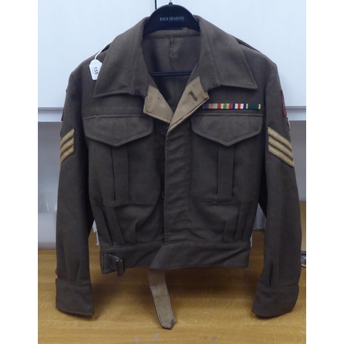 155 - A British battledress top with maroon arm badges, wing and reverse collar ribbon(Please Note: this l... 