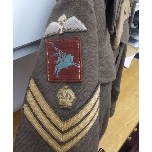 155 - A British battledress top with maroon arm badges, wing and reverse collar ribbon(Please Note: this l... 