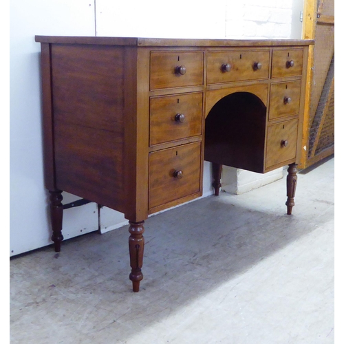 18 - A William IV mahogany kneehole desk, the crossbanded top set with a tooled green hide scriber, over ... 