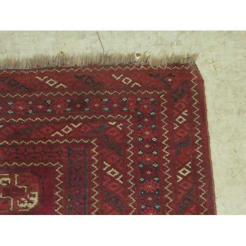 2 - A Bokhara rug, decorated with four columns of twelve octagonal guls, bordered by repeating diamond f... 