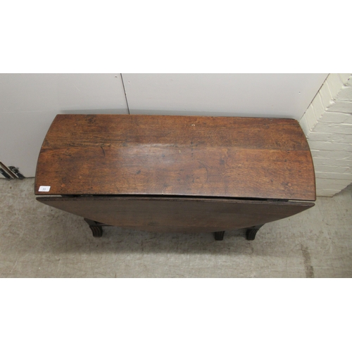 33 - An 18th/19thC oak gateleg table, the oval planked and dowelled top over an end drawer, raised on a r... 