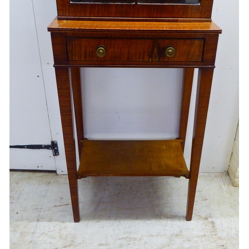 44 - An Edwardian satin mahogany veneered two part table cabinet, comprising a lockable fully glazed and ... 