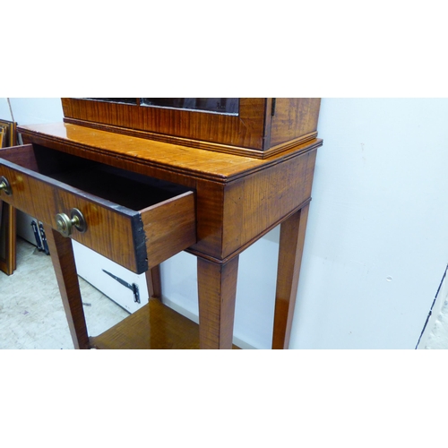 44 - An Edwardian satin mahogany veneered two part table cabinet, comprising a lockable fully glazed and ... 