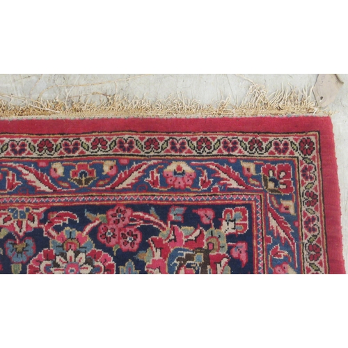 50 - A Kashan carpet, decorated with a central diamond shaped motif, profusely bordered by floral and fol... 