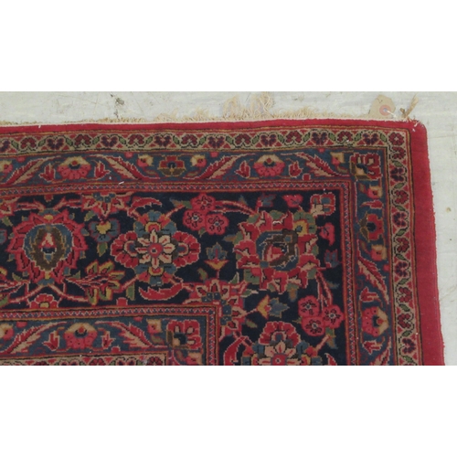 50 - A Kashan carpet, decorated with a central diamond shaped motif, profusely bordered by floral and fol... 