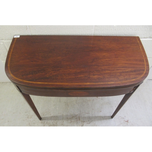 60 - An early 19thC mahogany and crossbanded satinwood D-shape tea table, the rotating foldover top raise... 