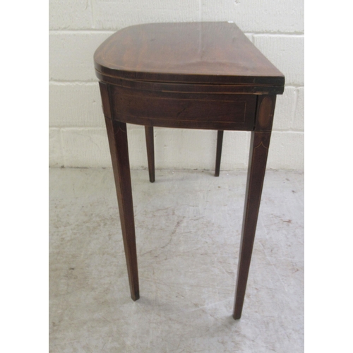 60 - An early 19thC mahogany and crossbanded satinwood D-shape tea table, the rotating foldover top raise... 