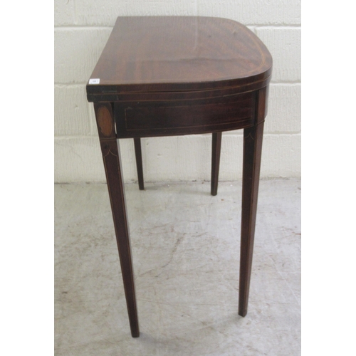 60 - An early 19thC mahogany and crossbanded satinwood D-shape tea table, the rotating foldover top raise... 