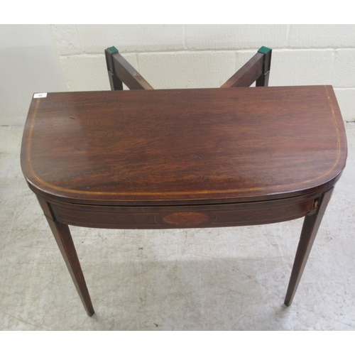 60 - An early 19thC mahogany and crossbanded satinwood D-shape tea table, the rotating foldover top raise... 