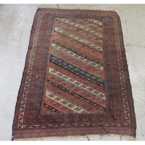 63 - A Kazak rug, decorated with angled, stylised decoration, on a multi-coloured ground  46