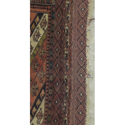 63 - A Kazak rug, decorated with angled, stylised decoration, on a multi-coloured ground  46