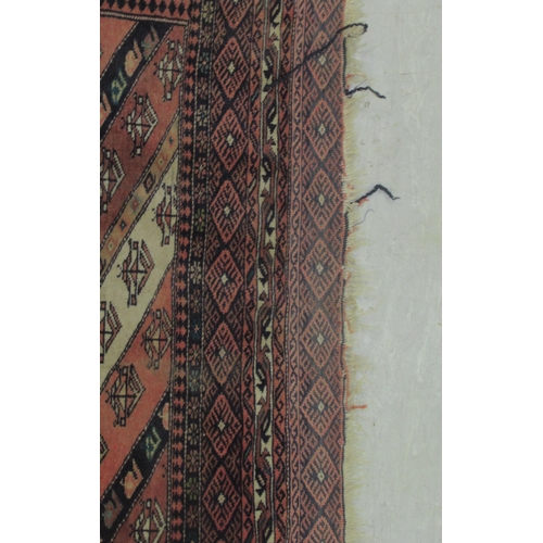 63 - A Kazak rug, decorated with angled, stylised decoration, on a multi-coloured ground  46