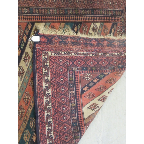 63 - A Kazak rug, decorated with angled, stylised decoration, on a multi-coloured ground  46