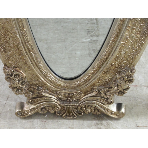 66 - A pair of Victorian style oval dressing mirrors, set in ornately moulded gilt frames, on folding eas... 