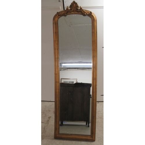 71 - A Victorian style dressing mirror, set in a moulded gilt frame, incorporating a foliate crest  70