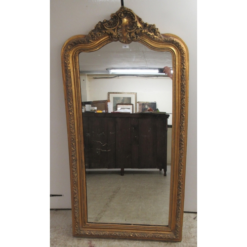 76 - A modern Victorian style dressing mirror, set in a bead moulded, foliate scrolled gilt frame, incorp... 