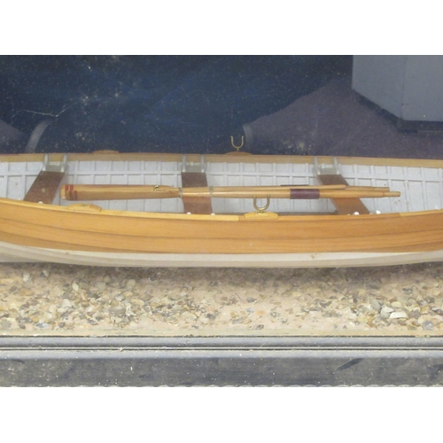 90 - A table-top model, a clinker built rowing boat with oars, total length 27