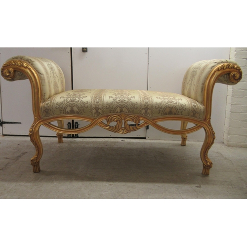 96 - A modern Louis XV inspired, carved giltwood framed window seat with scrolled ends and a shaped apron... 