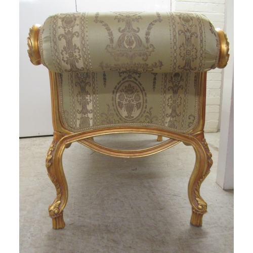 96 - A modern Louis XV inspired, carved giltwood framed window seat with scrolled ends and a shaped apron... 