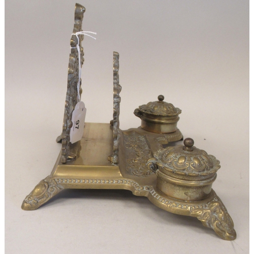 97 - A Victorian style brass deskstand, incorporating a letter rack, a pen channel and a pair of inkwell ... 