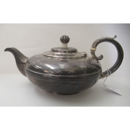 1 - A William IV silver teapot of squat, oval form with a scrolled handle  London 1830