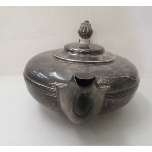 1 - A William IV silver teapot of squat, oval form with a scrolled handle  London 1830