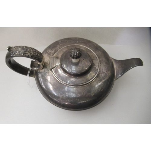 1 - A William IV silver teapot of squat, oval form with a scrolled handle  London 1830