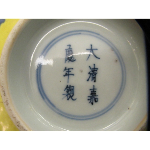 127 - A 19thC Chinese porcelain footed bowl, decorated with blue flowers and foliage, on a yellow ground  ... 