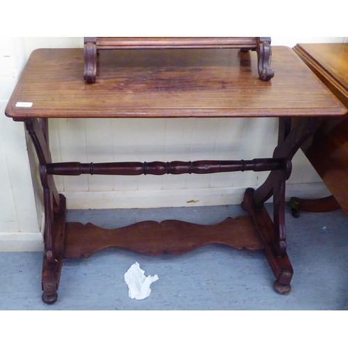 135 - A late 19thC walnut centre table, the top raised on opposing cross design supports, platforms and bu... 