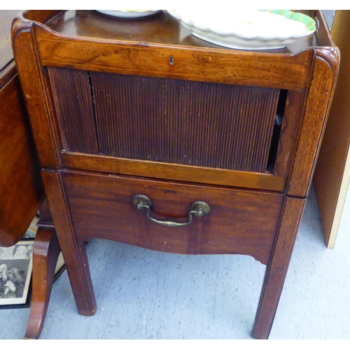 139 - A George III mahogany night commode, the tray design top with galleried, cut-out handles, over a com... 