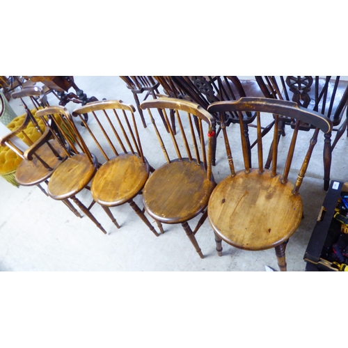 178 - A matched set of six early 20thC beech and elm framed spindle back kitchen chairs, each with a solid... 