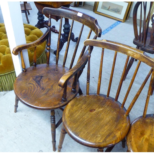 178 - A matched set of six early 20thC beech and elm framed spindle back kitchen chairs, each with a solid... 