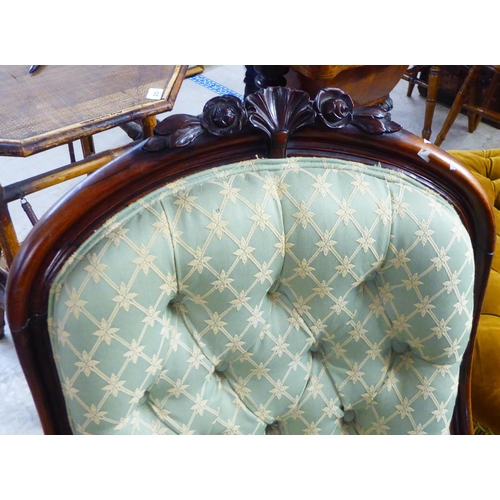 180 - A mid 19thC rosewood framed salon chair with a button upholstered green fabric back and seat, raised... 