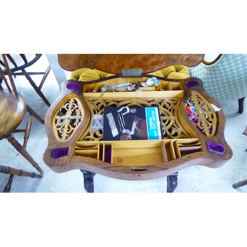 184 - A late Victorian walnut serpentine front sewing table, the hinged lid enclosing a fitted interior, r... 