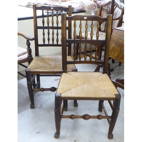 191 - A matched set of four early 19thC ash and oak framed Lancashire spindle back dining chairs, each wit... 