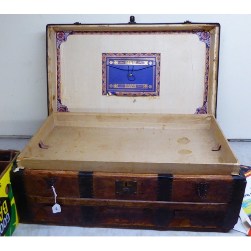 196 - A late 19th/early 20thC hide covered studded tinplate and beech bound cabin trunk with iron fittings... 