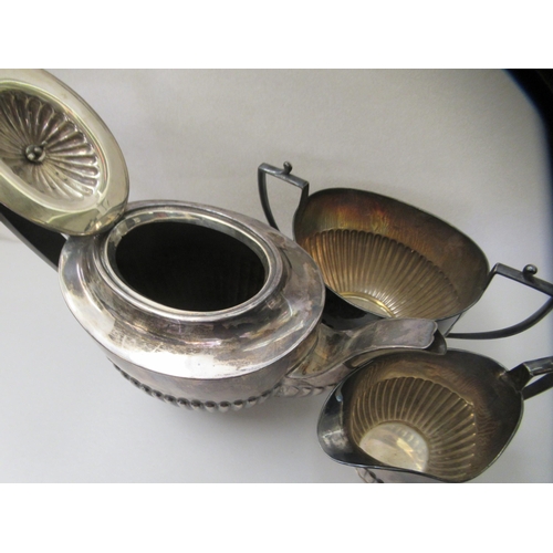 2 - An early 20thC silver three piece tea set of oval demi-reeded form  comprising a teapot, sugar ... 