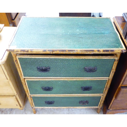 207 - An early 20thC bamboo framed three drawer dressing chest with embossed, green painted panels and iro... 