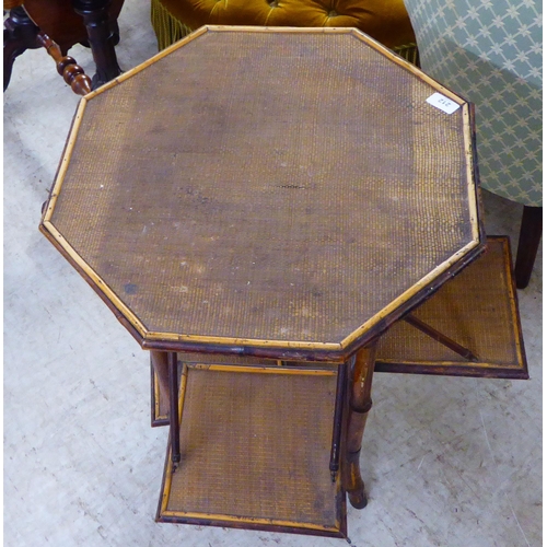 212 - An Edwardian bamboo framed and rattan, panelled, octagonal tea table with folding, outset panels  29... 