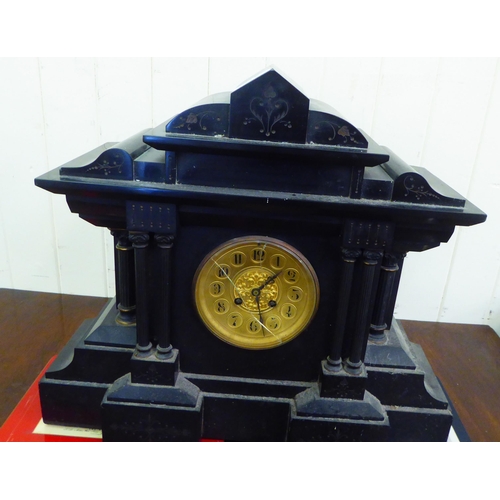 218 - A late Victorian black slate cased mantel clock of breakfront, architectural form; the movement face... 