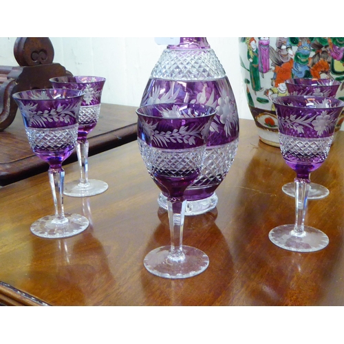 25 - A 20thC clear and amethyst coloured glass thumb moulded and diamond pattern cut decanter; and a matc... 