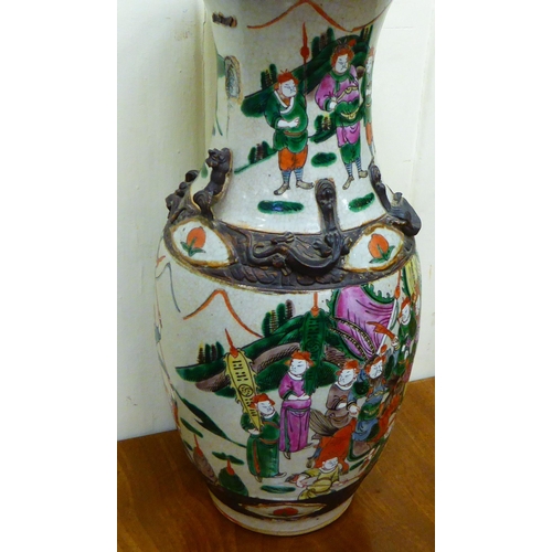 258 - An early 20thC Japanese crackle glazed porcelain vase, traditionally decorated with a battle scene&n... 