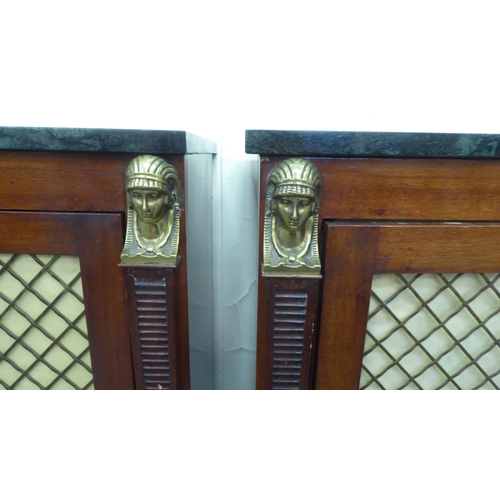 267 - A pair of Regency style mahogany cabinets, each top surmounted by a black and green mottled marble p... 